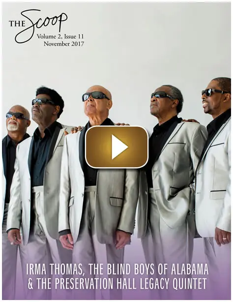 A group of men in matching silver suits and sunglasses posing confidently.