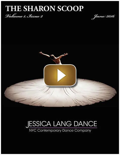 A dancer performs an impressive handstand on stage with dramatic lighting.