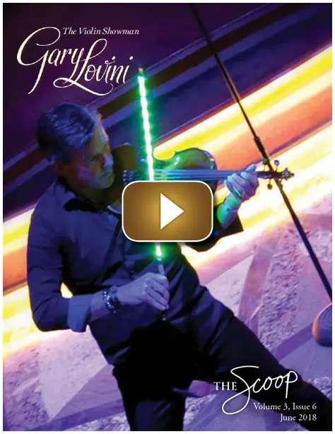 Man playing electric violin with dramatic lighting and colorful background.