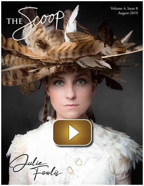 Portrait of a woman wearing an elaborate feathered hat and fur collar.