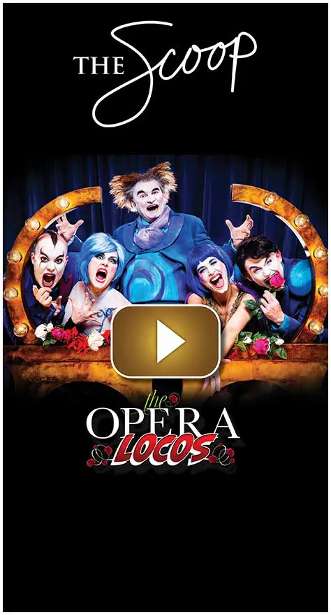 Cast of "Opera A Voces" in colorful costumes and makeup on stage.