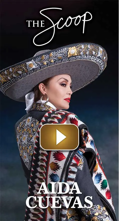 Woman dressed in traditional Mexican charro attire with a large sombrero.