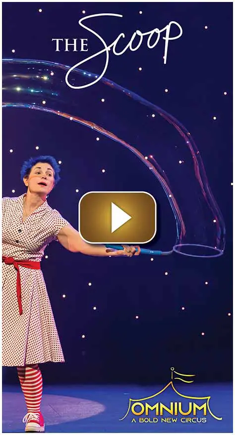 A woman creating a large bubble against a starry background.
