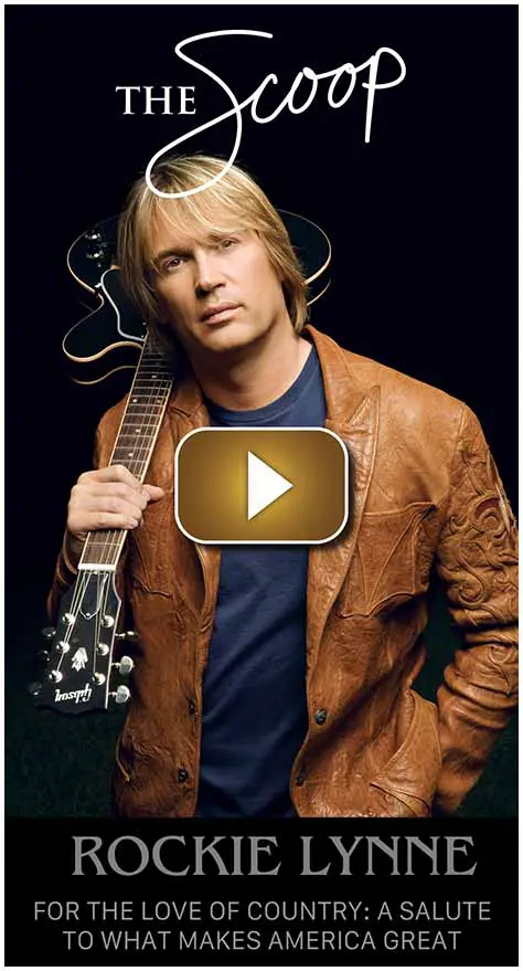Man with guitar wearing a brown leather jacket.