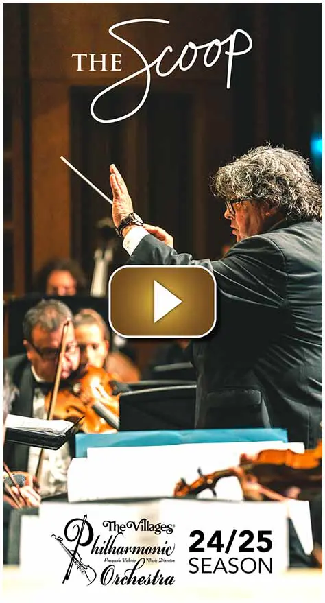 Conductor leading an orchestra during a live performance.