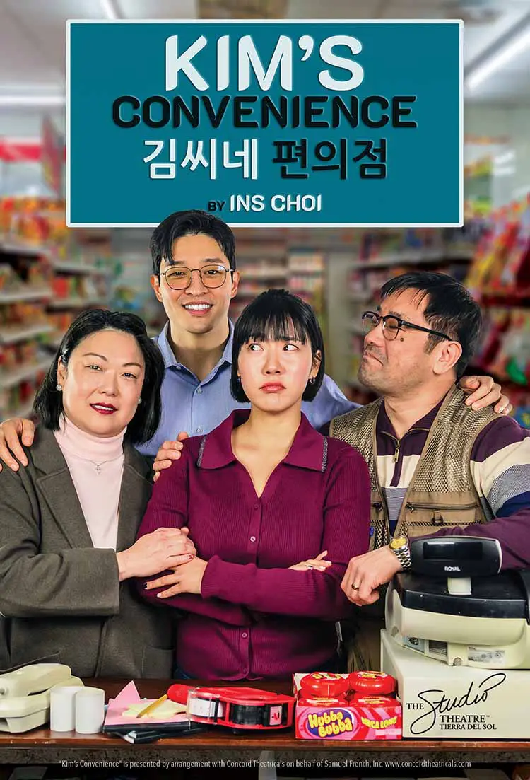 Four people posing in front of a shop sign with Korean text.