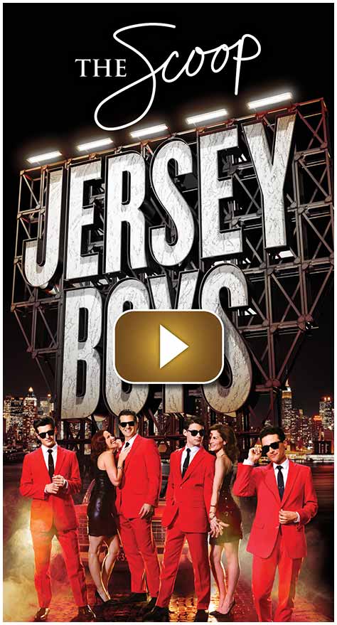 Cast of Jersey Boys posing in front of a large illuminated sign.